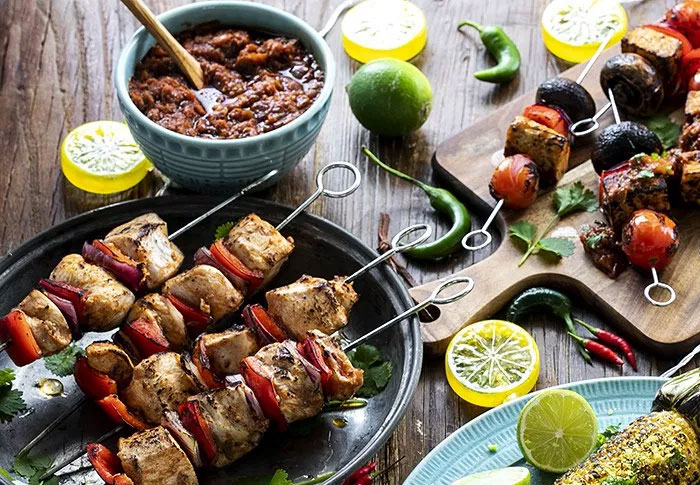 Summer BBQ Feast: chicken skewers, vegetarian tempeh skewers, and grilled corn.